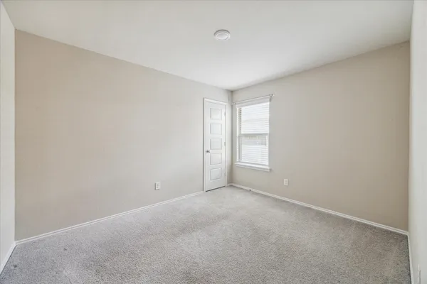 a view of an empty room and a window