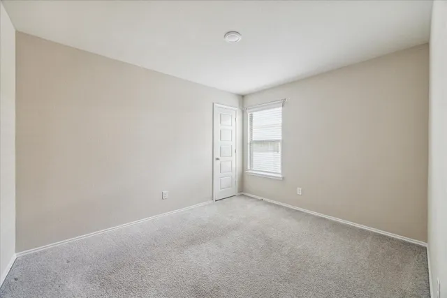 a view of an empty room and a window