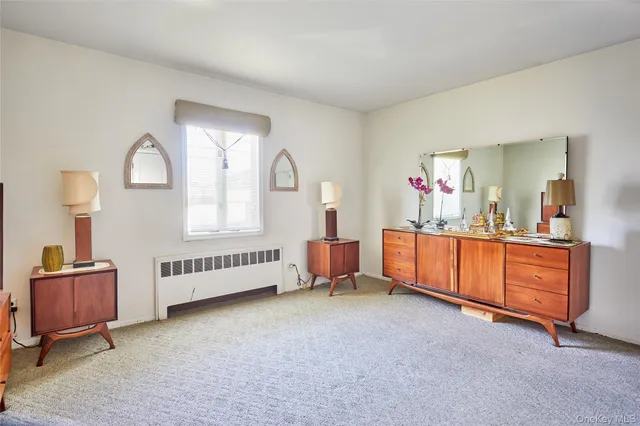 a bed room with furniture and a mirror