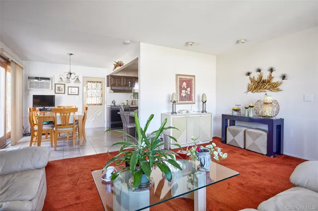a living room with furniture dining table a fireplace and a dining table with wooden floor