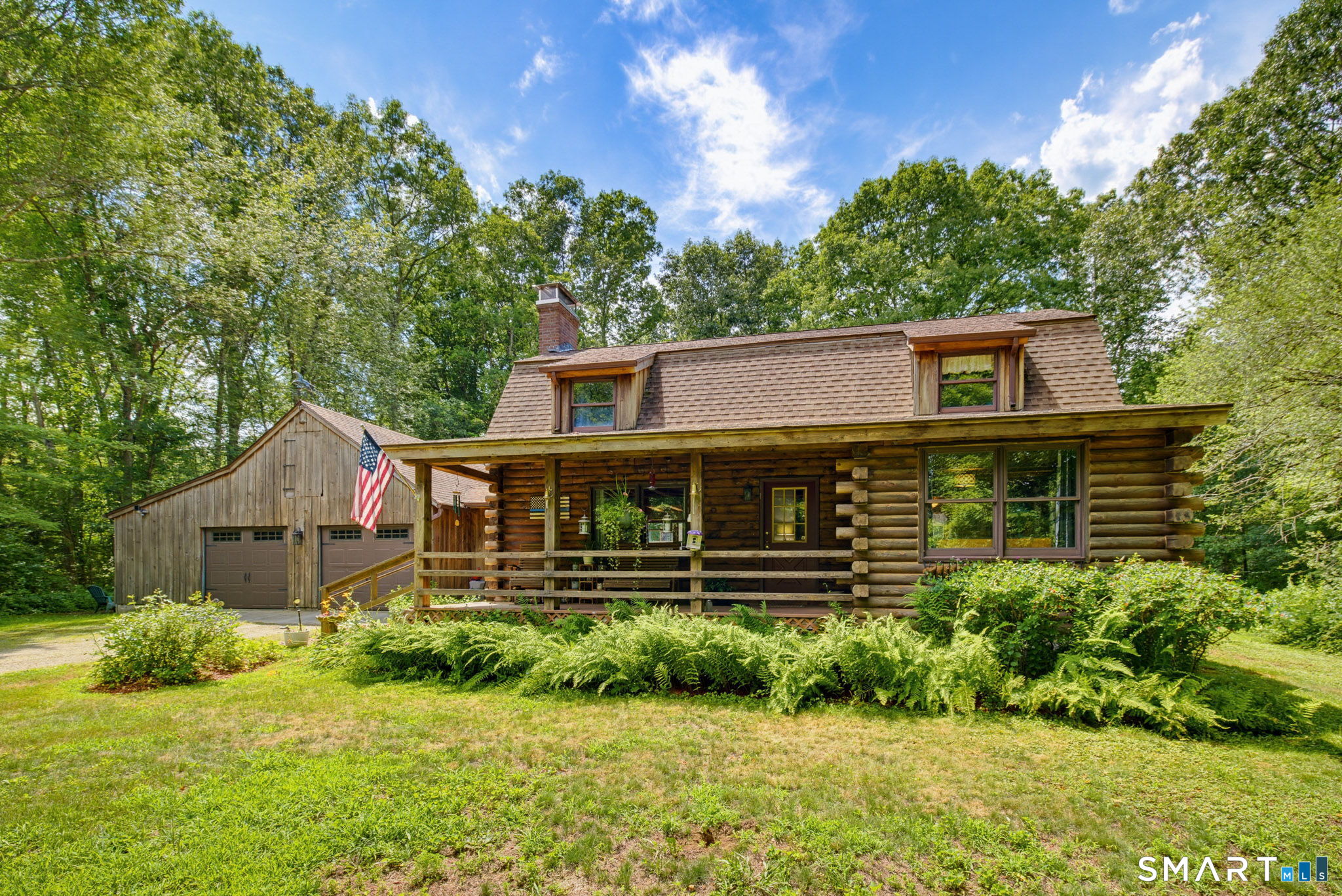 151 Fire Tower Road Eastford, CT 06242 - Photo 1 of 39 Landscaping around this log home adds pops of color to the front and back yards.