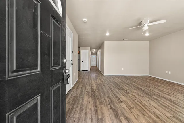 a view of a hallway with wooden floor