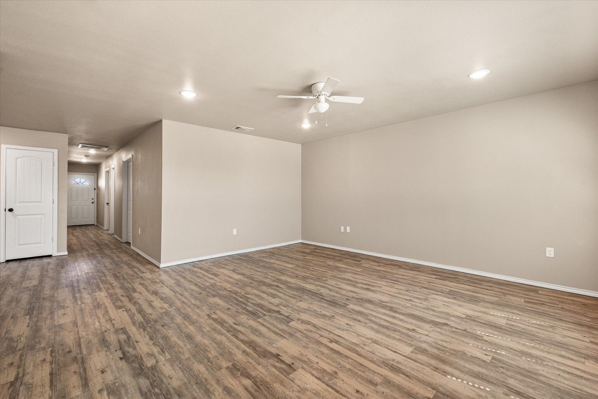 7412 5th Street, Unit 1 Lubbock, TX 79416 - Photo 6 of 16 wooden floor in an empty room with a window