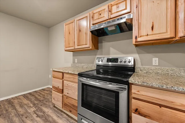 a kitchen with stainless steel appliances granite countertop a stove and a microwave
