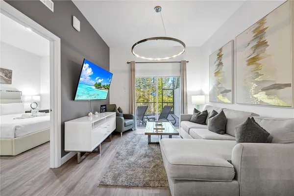 a living room with furniture a rug and a flat screen tv