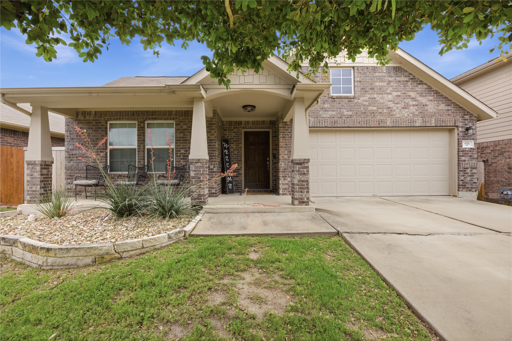 486 Pond View Pass Buda, TX 78610 - Photo 1 of 39 Brick exterior with a covered front porch featuring stone-clad columns