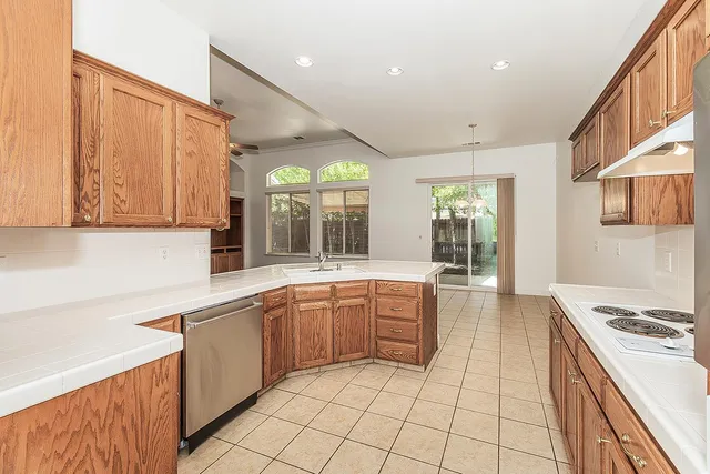 a large kitchen with stainless steel appliances lots of counter top space