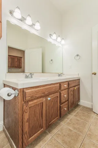 a spacious bathroom with a double vanity sink mirror and double
