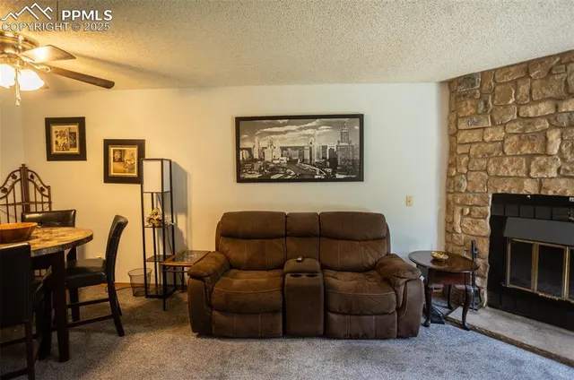 a living room with furniture a flat screen tv and a fireplace