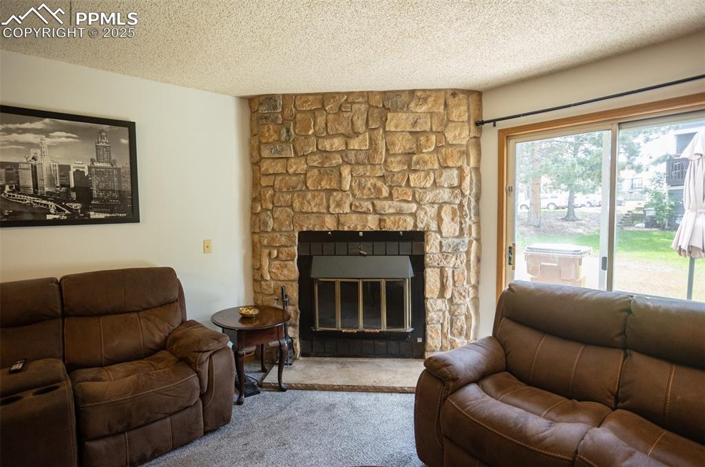 3515 Queen Anne Way Colorado Springs, CO 80917 - Photo 13 of 33 a living room with furniture and a fireplace