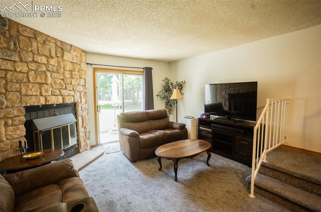3515 Queen Anne Way Colorado Springs, CO 80917 - Photo 14 of 33 a living room with furniture and a flat screen tv