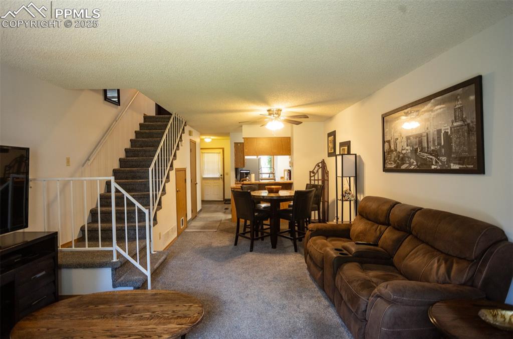 3515 Queen Anne Way Colorado Springs, CO 80917 - Photo 15 of 33 a living room with furniture and a dining table