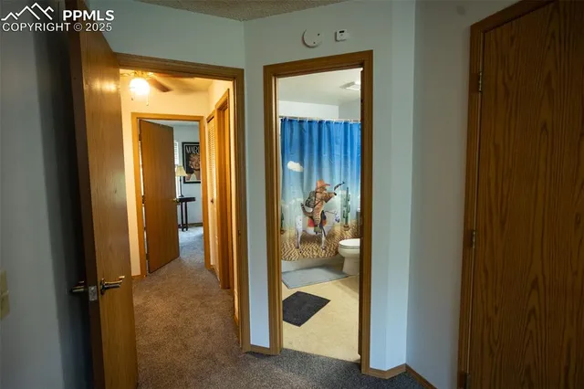 a view of a hallway with wooden shelves