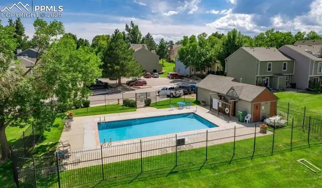 a aerial view of a house with porch and a garden