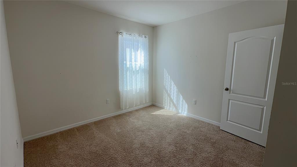 611 Autumn Stream Drive Auburndale, FL 33823 - Photo 18 of 30 a view of an empty room and a window
