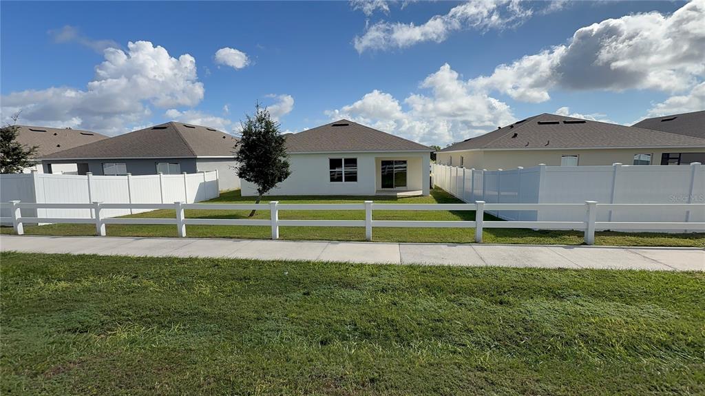 611 Autumn Stream Drive Auburndale, FL 33823 - Photo 22 of 30 a front view of a house with a yard