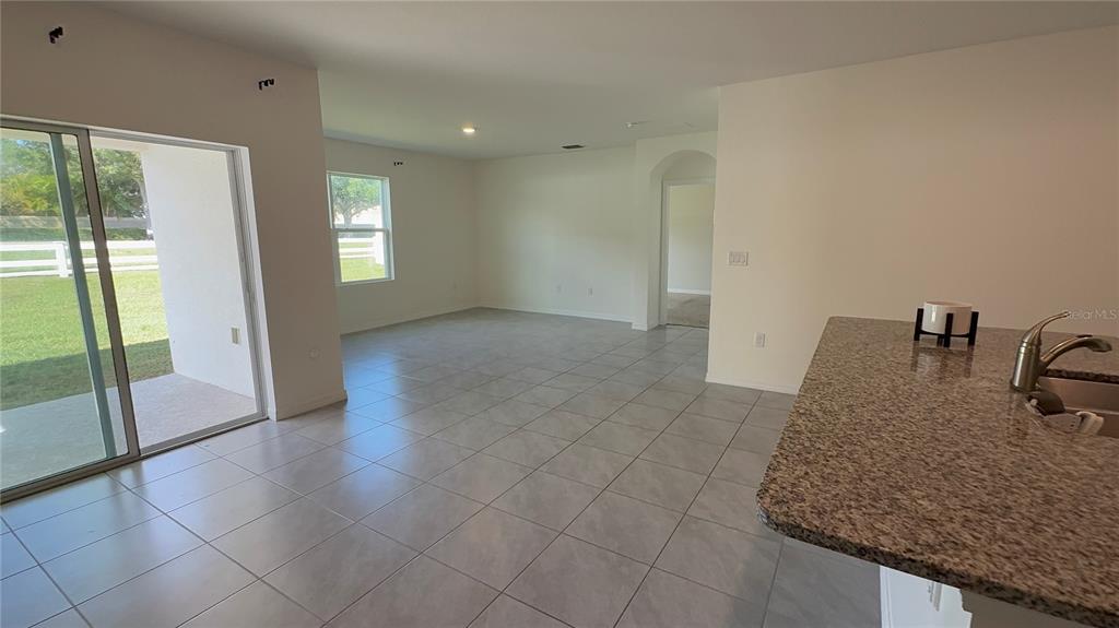 611 Autumn Stream Drive Auburndale, FL 33823 - Photo 6 of 30 a kitchen with granite countertop a sink and a granite counter tops
