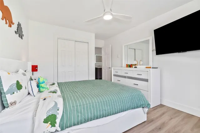 a bedroom with a bed and a flat screen tv