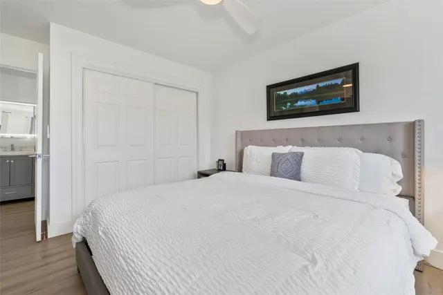 a bedroom with a bed and a painting