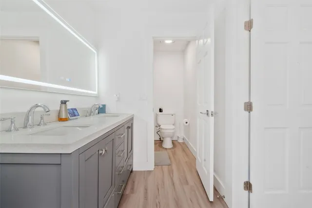 a bathroom with a sink a mirror and a toilet