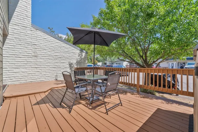 a view of a wooden deck with furniture