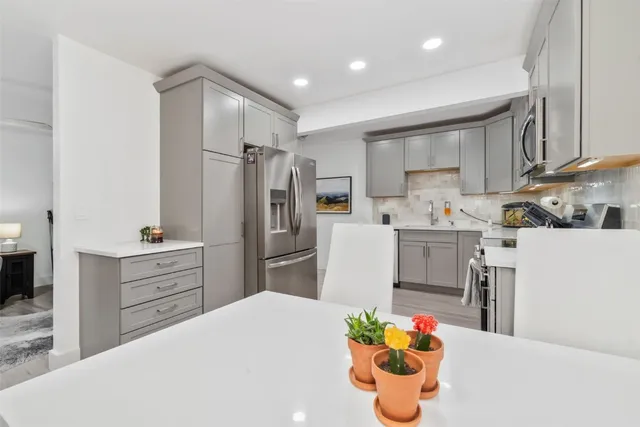 a kitchen with refrigerator a oven a sink and dishwasher
