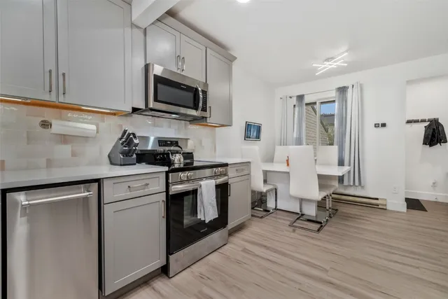 a kitchen with a sink a microwave and cabinets
