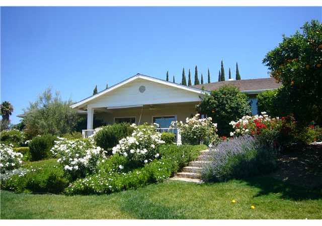 2146 Gum Tree Lane Fallbrook, CA 92028 - Photo 1 of 23 An explosion of Color with Roses everywhere! Big Front Porch with Views overlooking a small valley.