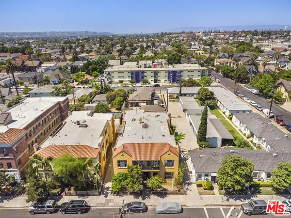 an aerial view of a houses with a street
