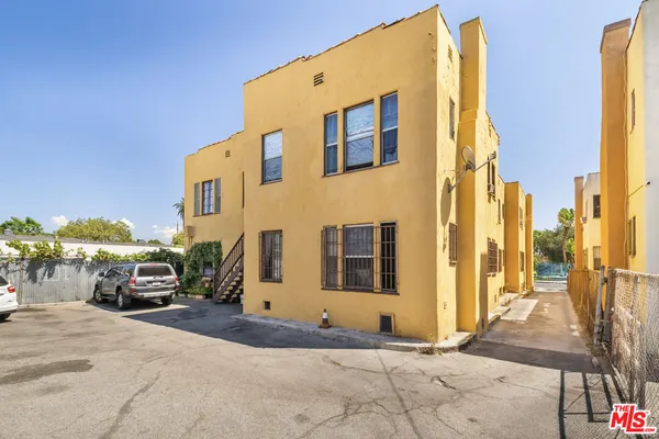 a view of a building with car parked