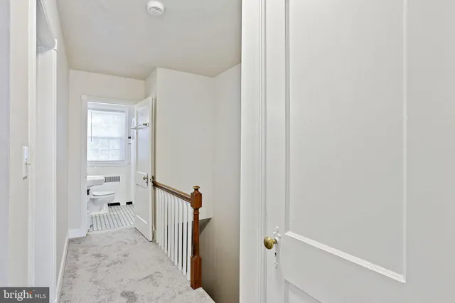 a view of a hallway with a wooden cabinets