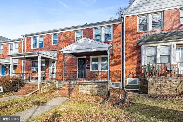 a front view of a residential apartment building with a yard