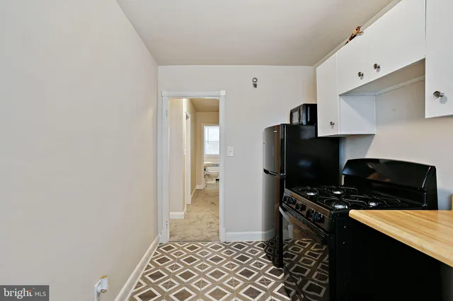 a kitchen with a sink and a stove top oven