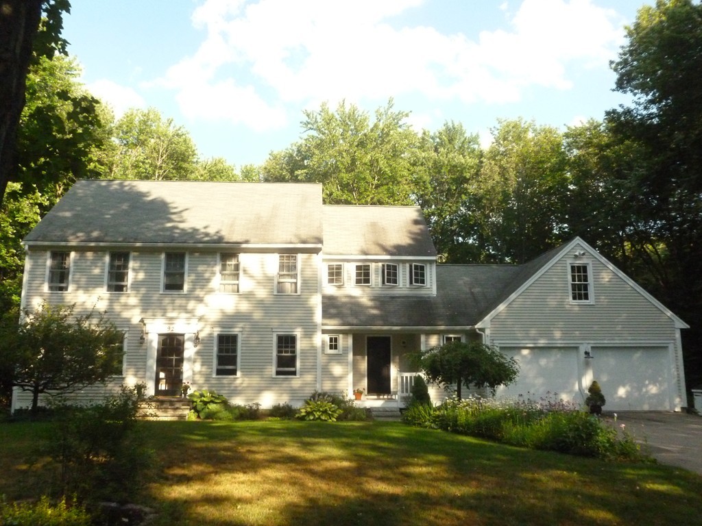 92 Green Road Bolton, MA 01740 - Photo 1 of 17 a front view of a house with a yard and garage