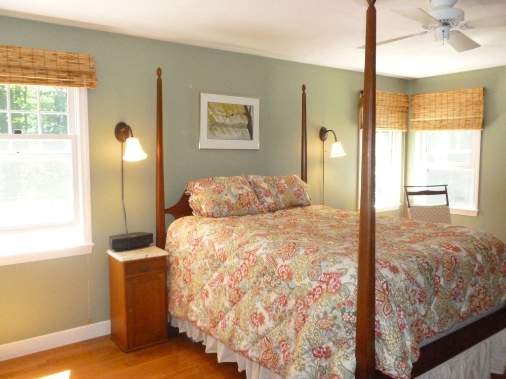 92 Green Road Bolton, MA 01740 - Photo 13 of 17 a bedroom with a bed and a chandelier