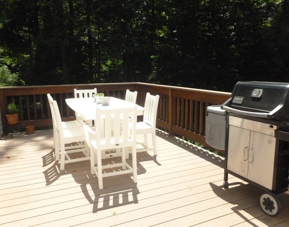 92 Green Road Bolton, MA 01740 - Photo 15 of 17 a view of a chairs and table on the deck