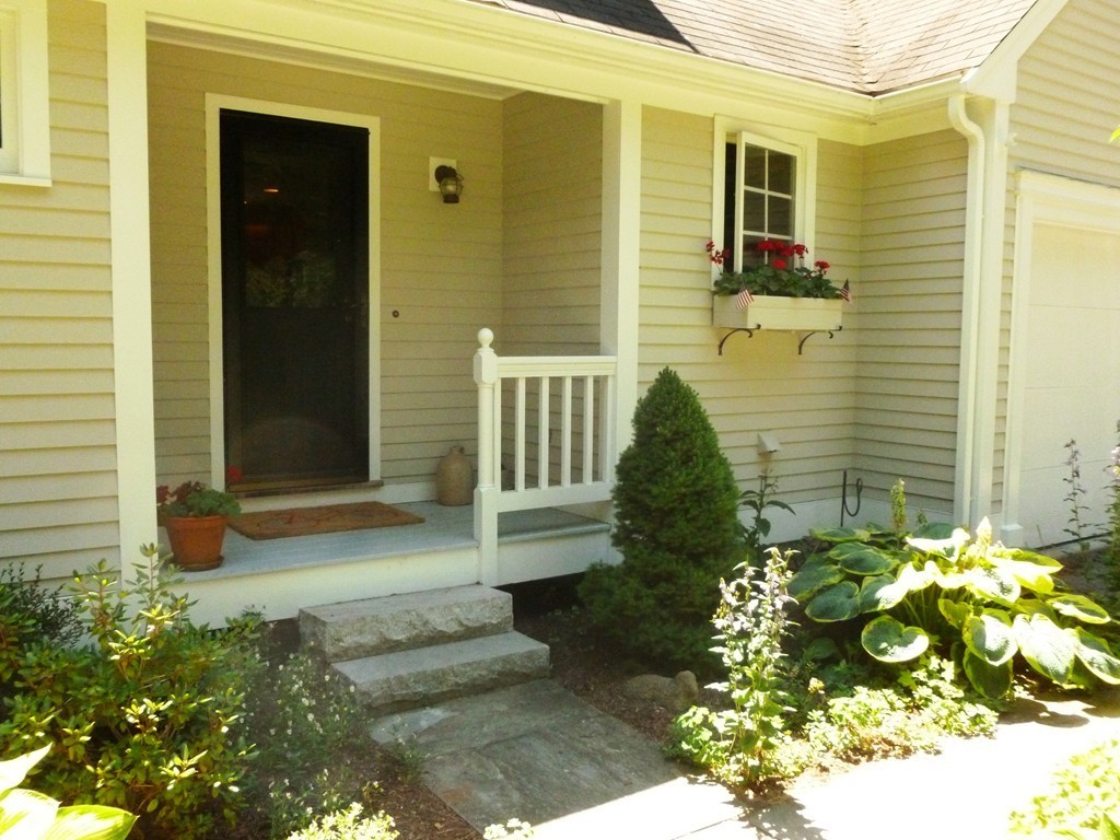 92 Green Road Bolton, MA 01740 - Photo 2 of 17 a front view of a house with a garden