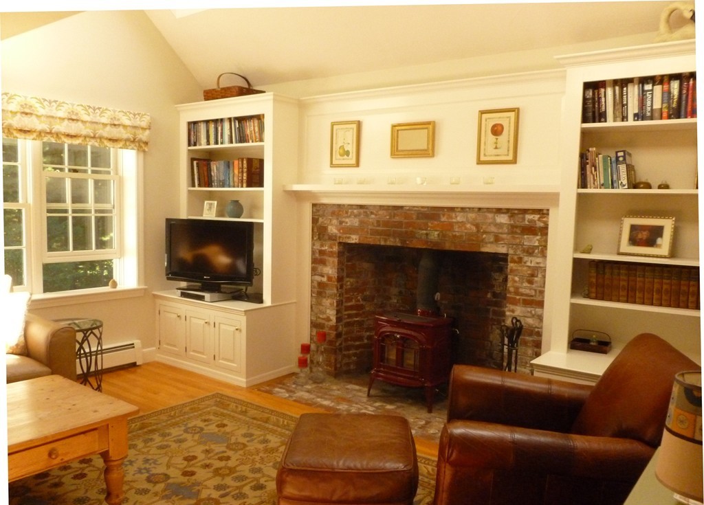 92 Green Road Bolton, MA 01740 - Photo 3 of 17 a living room with furniture a flat screen tv and a fireplace