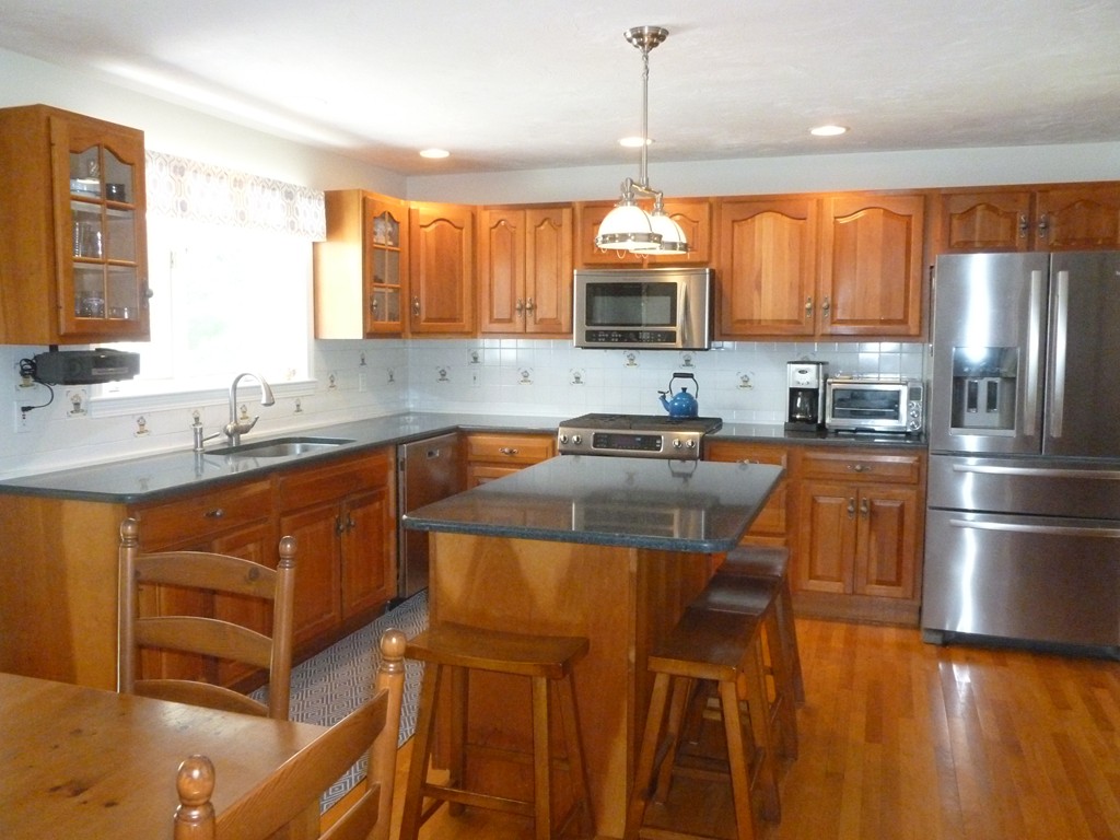 92 Green Road Bolton, MA 01740 - Photo 5 of 17 a kitchen with stainless steel appliances granite countertop a sink window and cabinets
