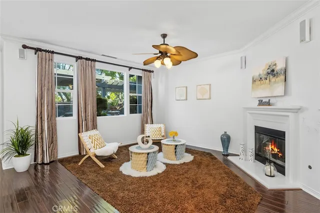 a living room with furniture a window and a fireplace