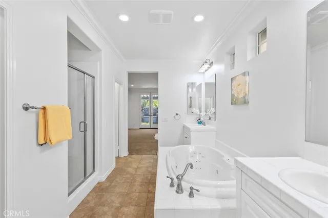 a bathroom with a tub sink and mirror