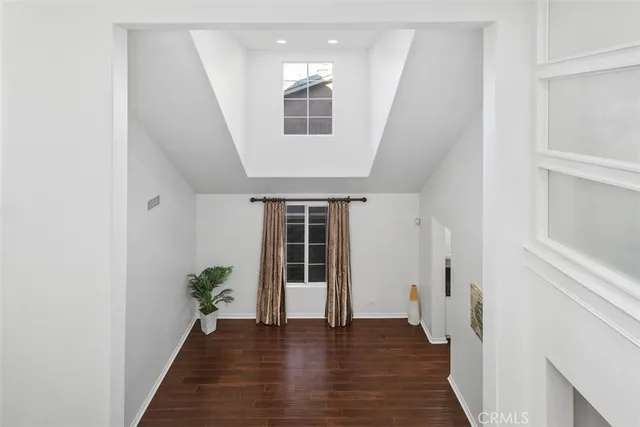 a hallway with wooden floor and plants