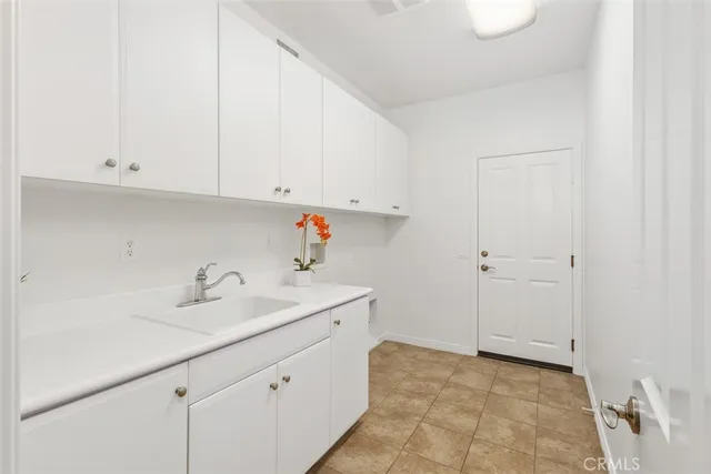 a bathroom with a sink and cabinets