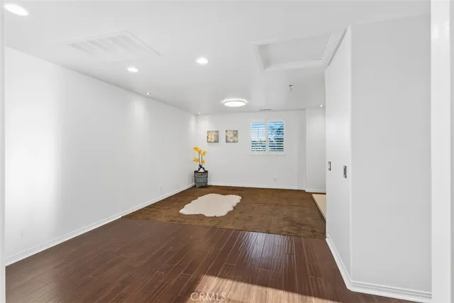 a view of a room with wooden floor and window