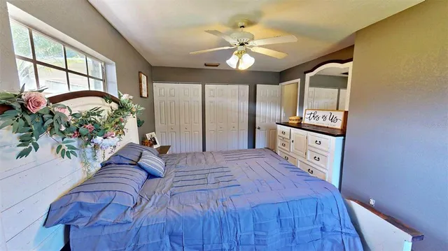 a spacious bedroom with a bed and a chandelier