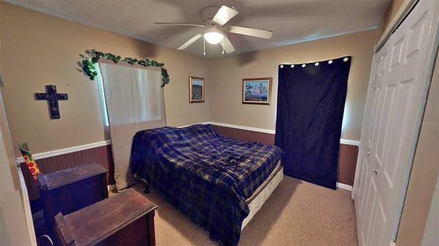 a bedroom with bed and wooden floor