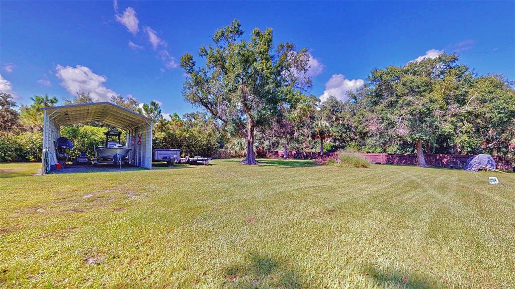 635 Bost Road Wauchula, FL 33873 - Photo 38 of 39 a view of a yard with a tree