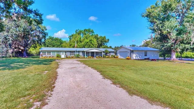 a view of house with outdoor space and garden