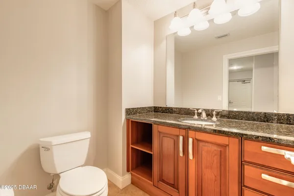 an empty room with windows and cabinet