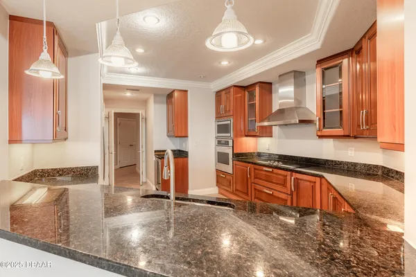 a kitchen with stainless steel appliances granite countertop a stove and a sink